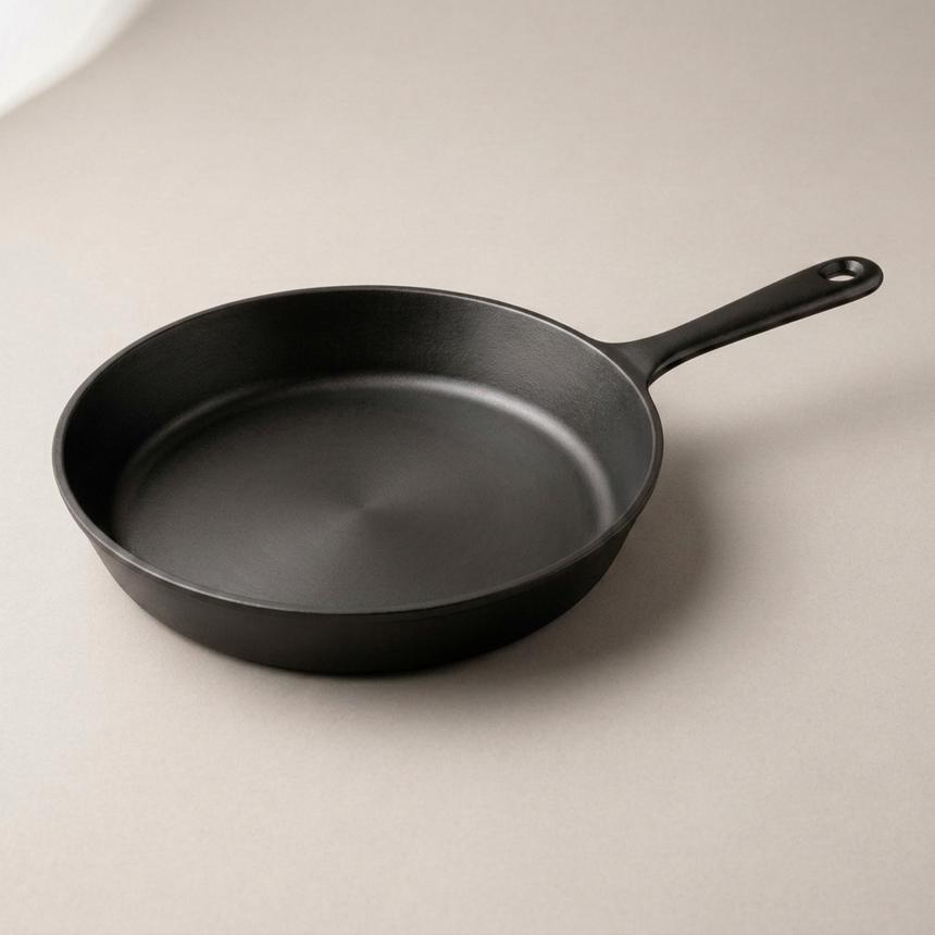 The Field Company skillet — smooth matte gray-black iron with the slim straight vintage-style handle.