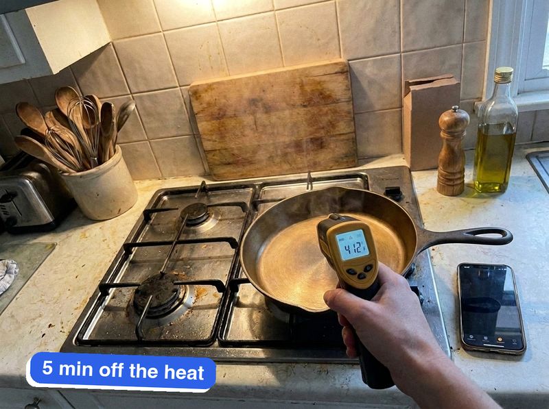 My infrared thermometer reading 412°F on the iLume's cooking surface, five minutes off the burner.