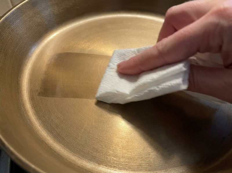 A folded paper towel gliding across the iLume's polished bronze surface in one clean streak.